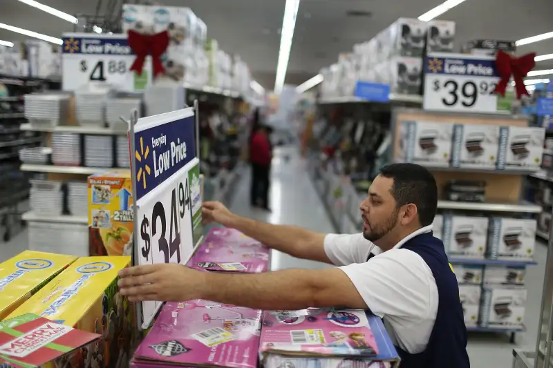 Jaime Vado fixes a display in the aisle at a Walmart store in Miami, Florida.