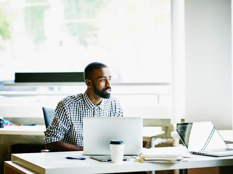 Businessman working on laptop at workstation