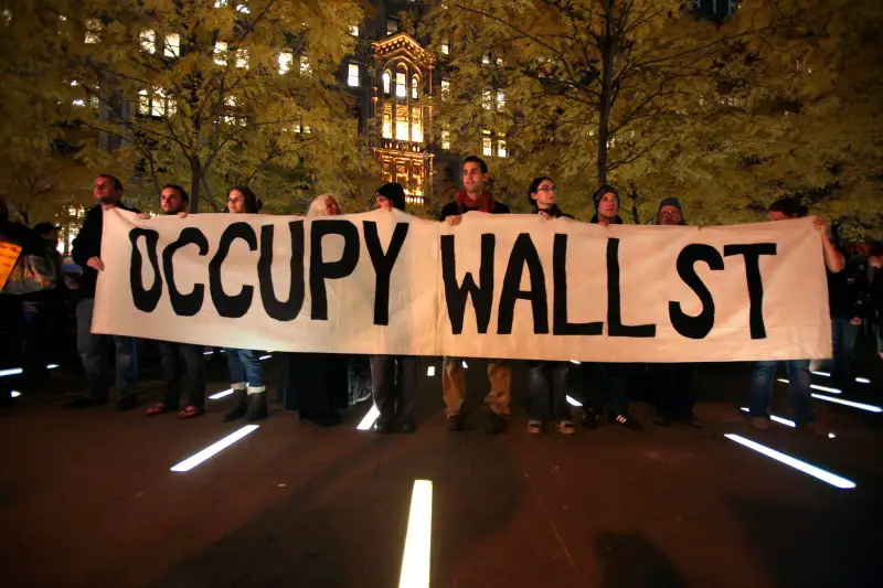 Members of Occupy Wall Street stand in triumph after a court order allowed them to reenter Zuccotti