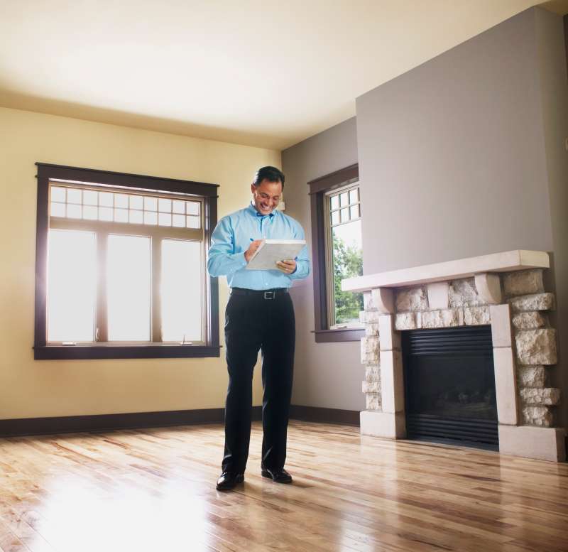 Man taking notes in empty house