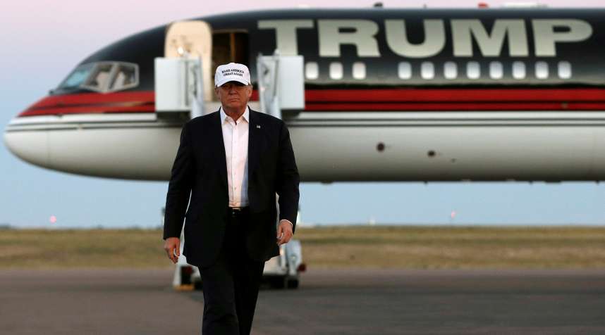 Republican presidential nominee Donald Trump walks off his plane at a campaign rally in Colorado Springs, Colorado, September 17, 2016.