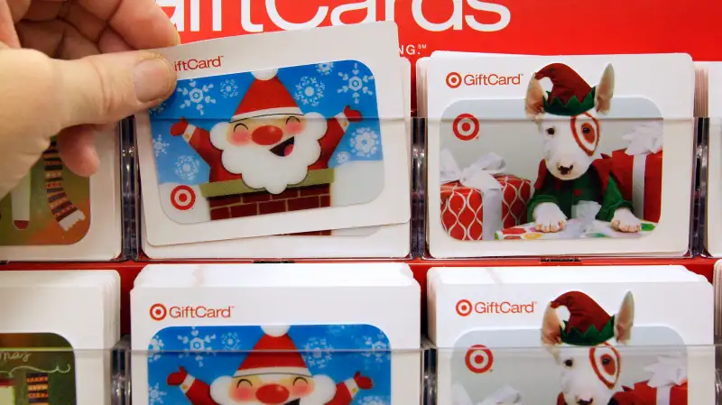 An early bird  Black Friday' shopper pulls a gift card from the rack at Target in Aurora, Ohio, Friday, Nov. 28, 2008.