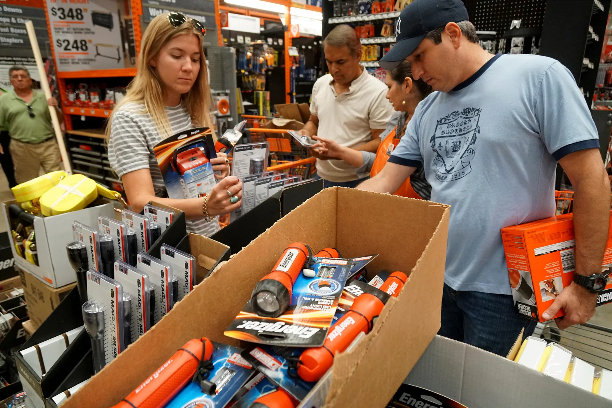 Customers shop for flashlights and batteries at a Home Depot Inc. store in Miami, Florida, on Oct. 4, 2016. 