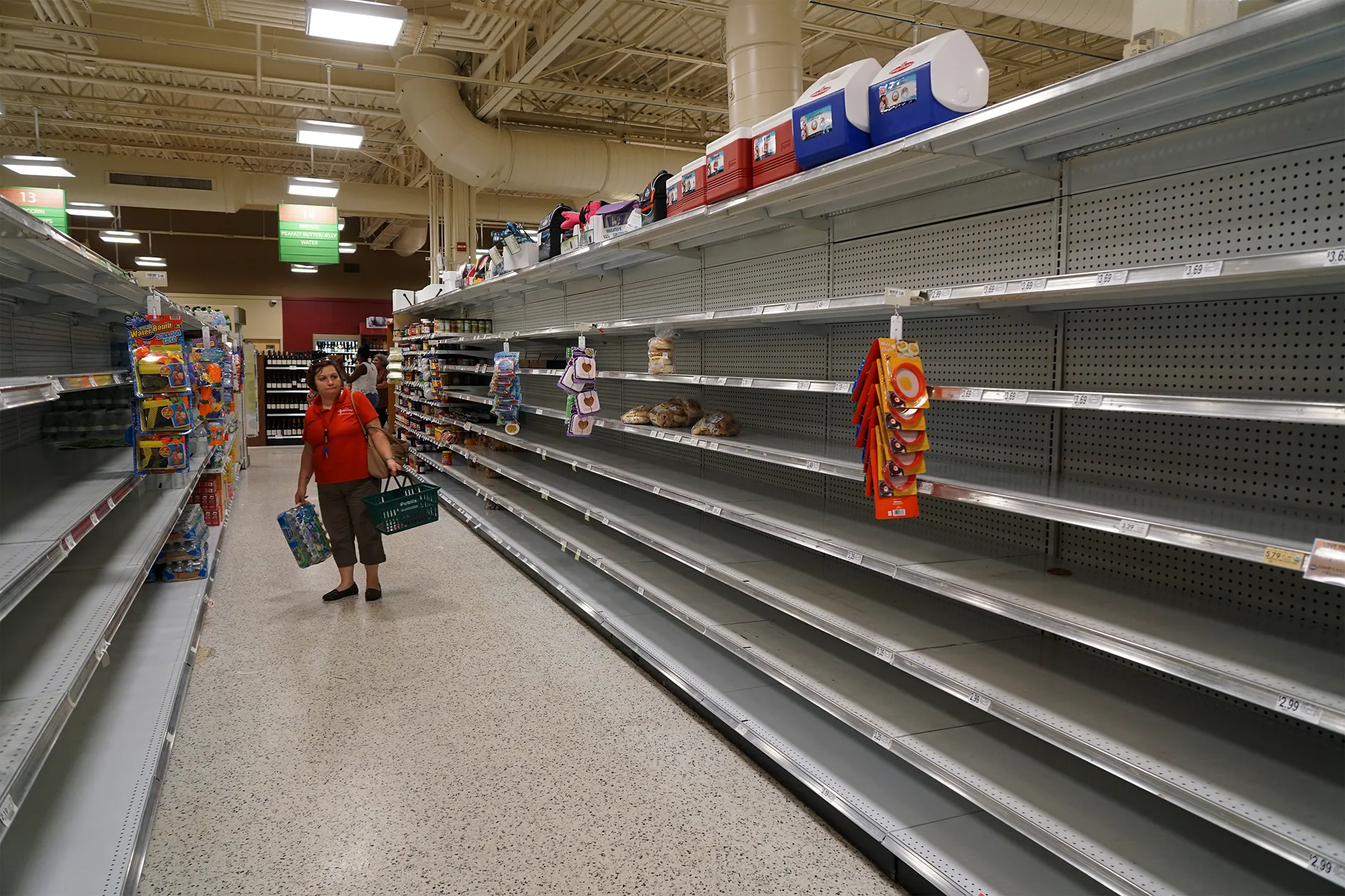 Customers browse empty shelves at a Publix Super Markets Inc. store ahead of Hurricane Matthew making landfall in West Palm Beach, Florida, on Oct. 5, 2016. 