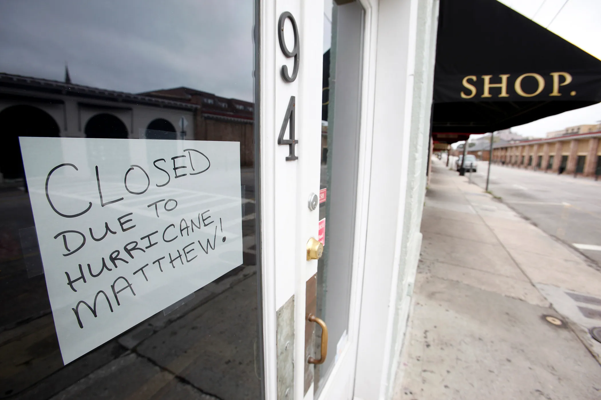 A sign in a shop window explains that they are closed due to the threat of Hurricane Matthew, in the mostly-empty historic district of Charleston, South Carolina on October 6, 2016.