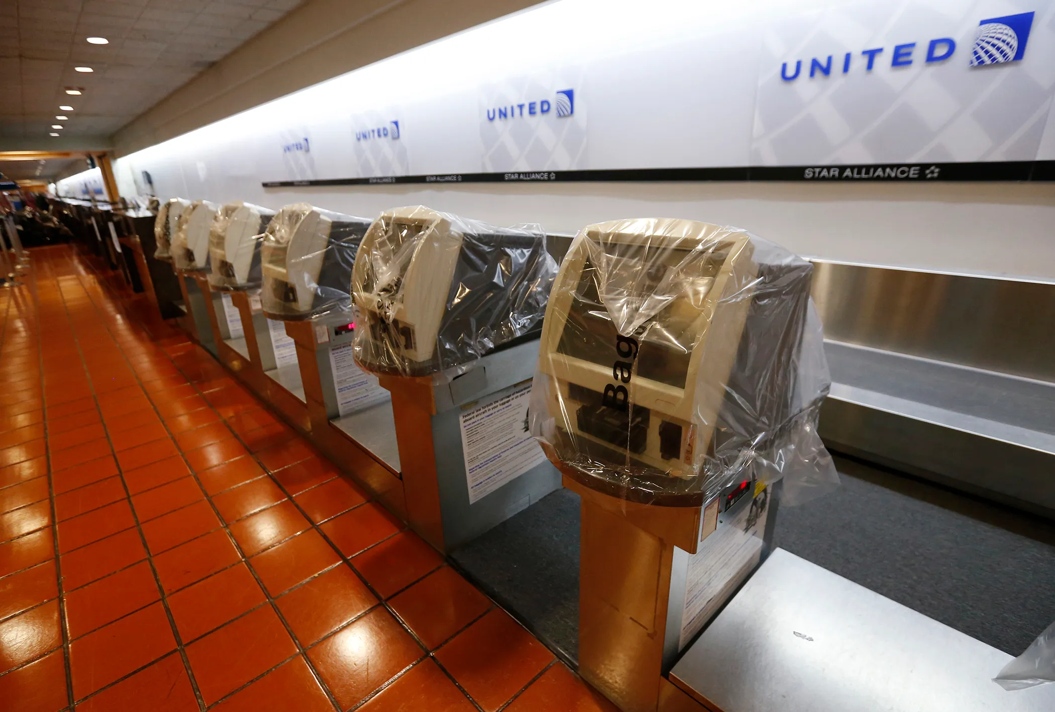 Ticketing machines are covered in plastic and flights in and out of the Palm Beach International airport in the afternoon as Hurricane Matthew advances, Thursday, Oct. 6, 2016, in West Palm Beach, Fla. The National Hurricane Center in Miami said the storm's maximum sustained winds had strengthened to 140 mph as of late Thursday morning and were expected to maintain their strength as the storm approaches the Florida coast.