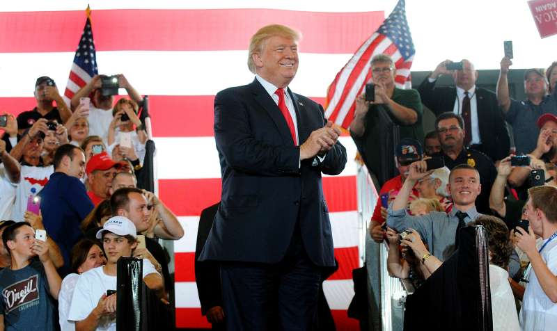 Republican presidential nominee Donald Trump arrives on stage for a rally at Southeastern Livestock Pavillion on October 12, 2016 in Ocala, Florida.