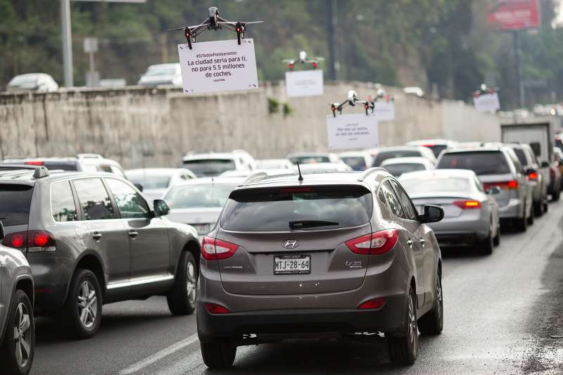 Uber Technologies Inc. drones advertise uberPOOL above traffic on a highway in Mexico City, Mexico, on Friday, June 17, 2016.