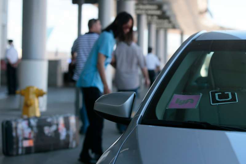 Uber and Lyft cars drop off passengers at the Bradley terminal at LAX, October 20, 2015.