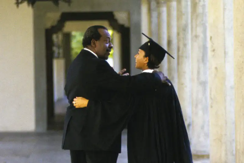 father with daughter who is college graduate