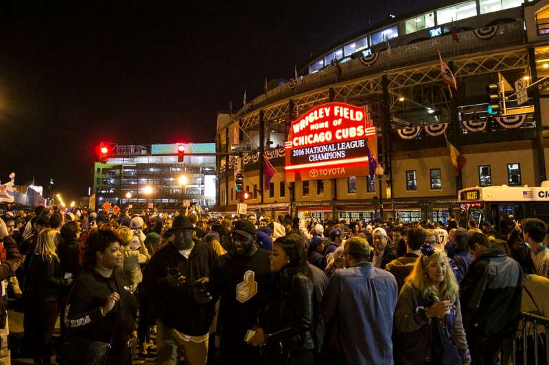 People congregate outside Wrigley Field after the Chicago Cubs defeated the Los Angeles Dodgers 5-0 in Game 6 of baseball's National League Championship Series, Saturday, Oct. 22, 2016, in Chicago. The Cubs advanced to the World Series.