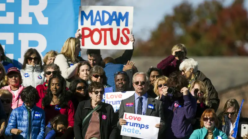 Attendees hold signs as Hillary Clinton, 2016 Democratic presidential nominee, not pictured, speaks during a campaign event in Manchester, New Hampshire, U.S., on Monday, Oct. 24, 2016. Clinton made the case for herself in the presidential race against Donald Trump during rallies in Pennsylvania, and in a sign of her campaign's increasing outreach, also made a pitch for the efforts by Democrats to gain control of the Senate.