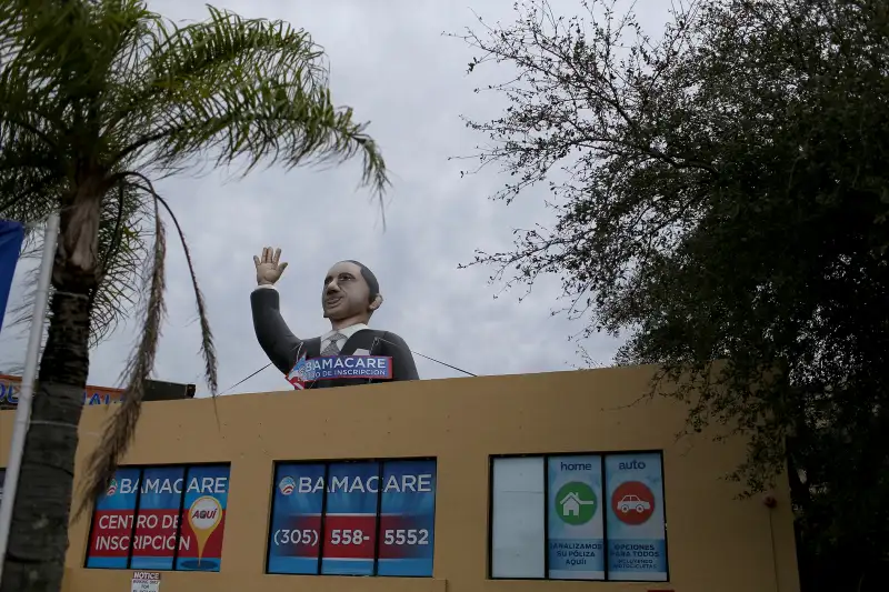 A sign waves from the top of insurance co. roof advertising for the Affordable Care Act, also known as Obamacare, as the company tries to sign people up before the February 15th deadline on February 5, 2015 in Miami, Florida.