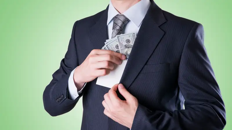 pulling money out of suit pocket