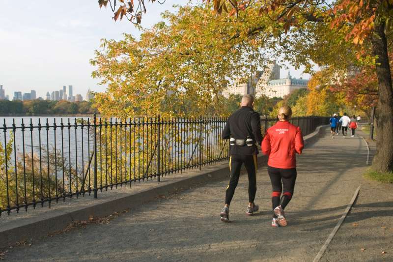 A couple runs around the Reservoir in Central Park, New York