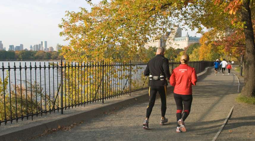 A couple runs around the Reservoir in Central Park, New York