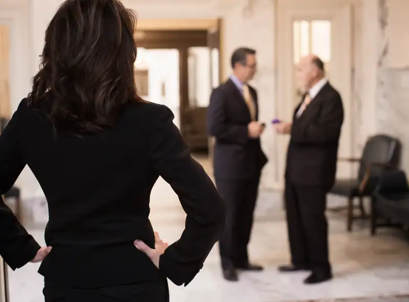 Caucasian politician watching men in government building