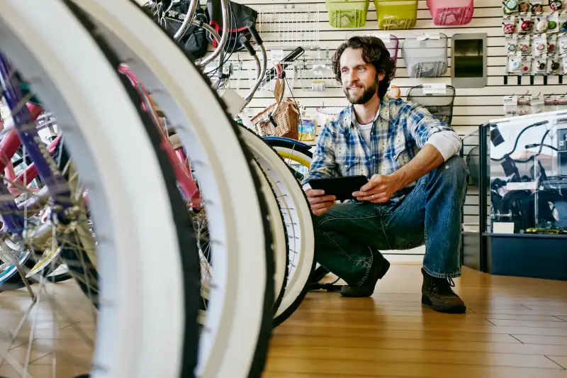 Caucasian man working in bicycle shop