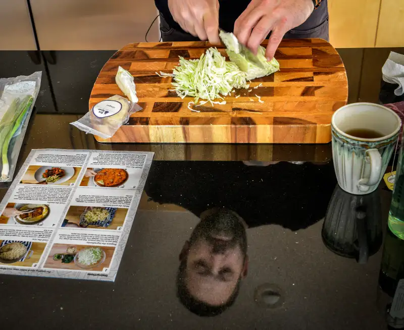 Chef Mike Isabella prepares a meal sent to him by Blue Apron, the online meal delivery service, in his home kitchen in Washington, DC.