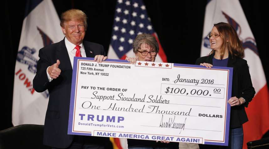 Donald Trump awards a $100,000 check to a veterans charity during a campaign event in Sioux City, Iowa.
