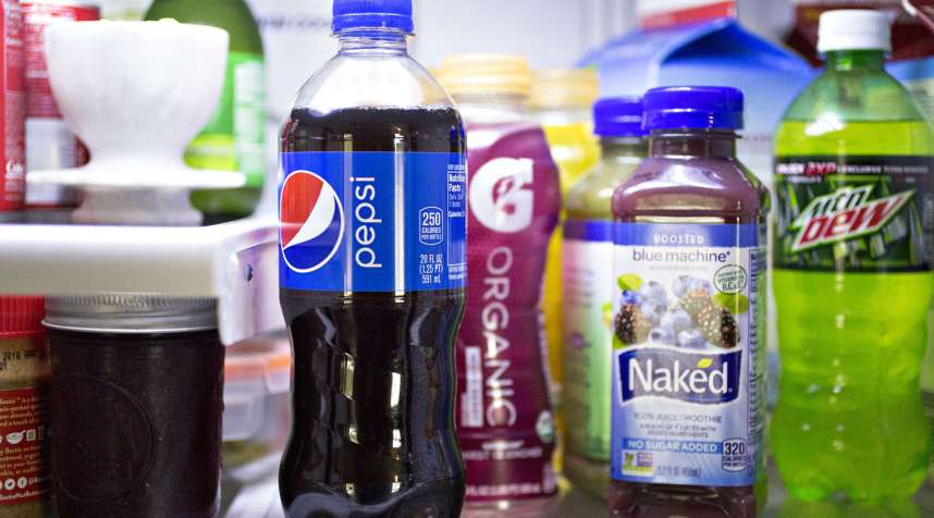 Bottles of PepsiCo Inc: Pepsi, Gatorade G Organic, Naked juice smoothie, and Mountain Dew brand beverages