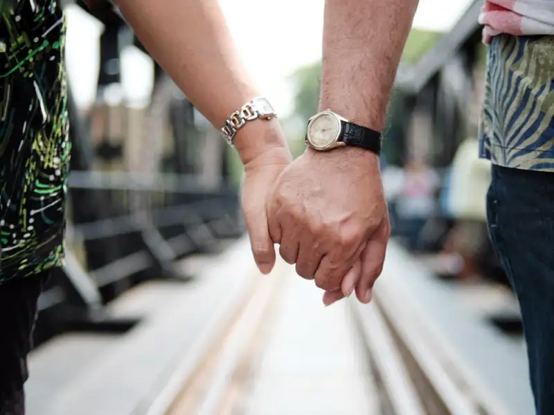 couple with watches holding hands