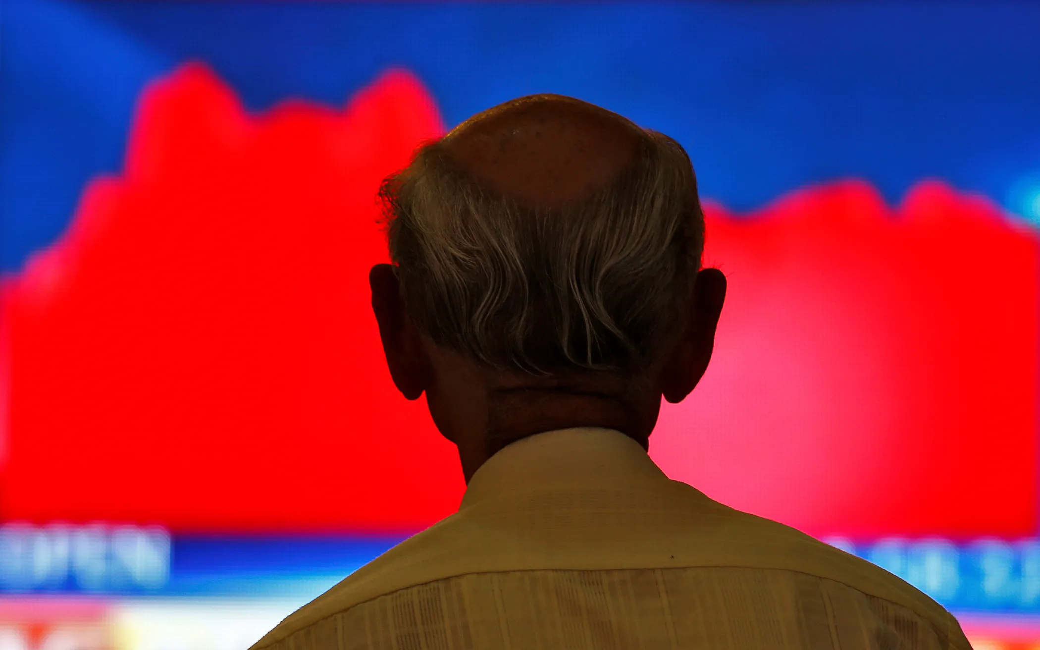 A man looks at a screen displaying news of markets update inside the Bombay Stock Exchange (BSE) building in Mumbai, India, November 9, 2016.