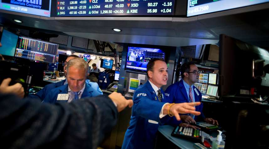 Traders work on the floor of the New York Stock Exchange (NYSE) in New York, U.S., on Wednesday, Nov. 9, 2016. U.S. stocks fluctuated in volatile trading in the aftermath of Donald Trump's surprise presidential election win, as speculation the Republican will pursue business-friendly policies offset some of the broader uncertainty surrounding his ascent.