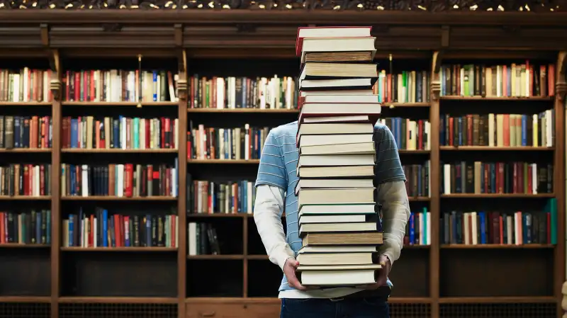 Student burdened with books.