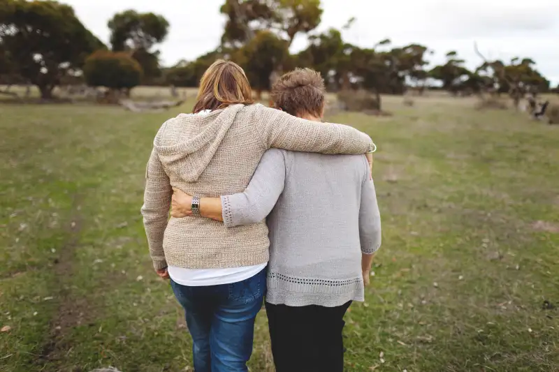 woman walking with senior mother