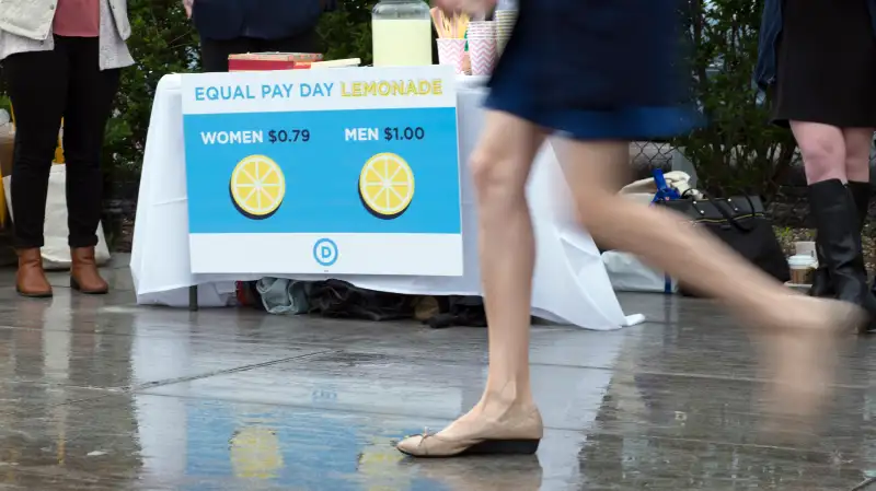 Democratic National Committee (DNC) women host an Equal Pay Day event with a lemonade stand where women pay 79 cents per cup and men pay $1 per cup, to highlight the wage gap on April 12, 2016 in Washington, DC.