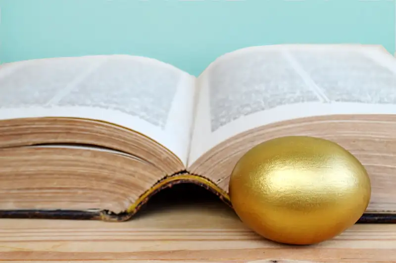 gold egg and book