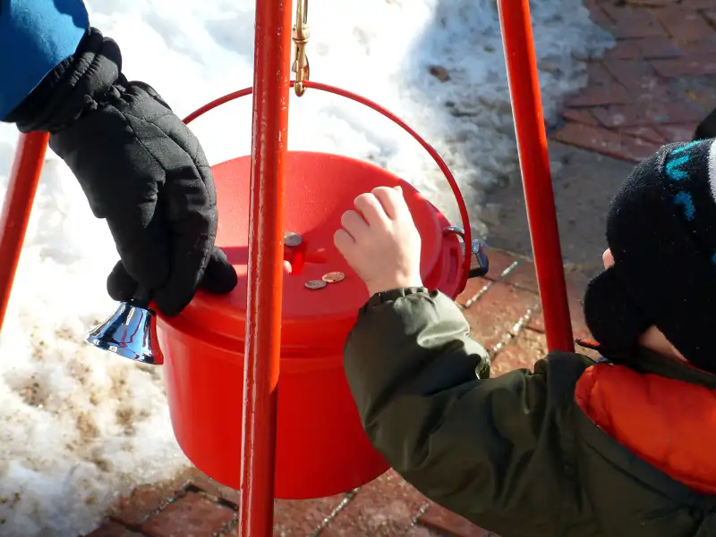 Boy donates coins during holiday season