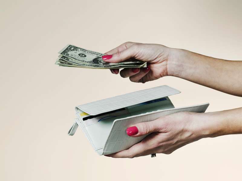 Hands with billfold and cash