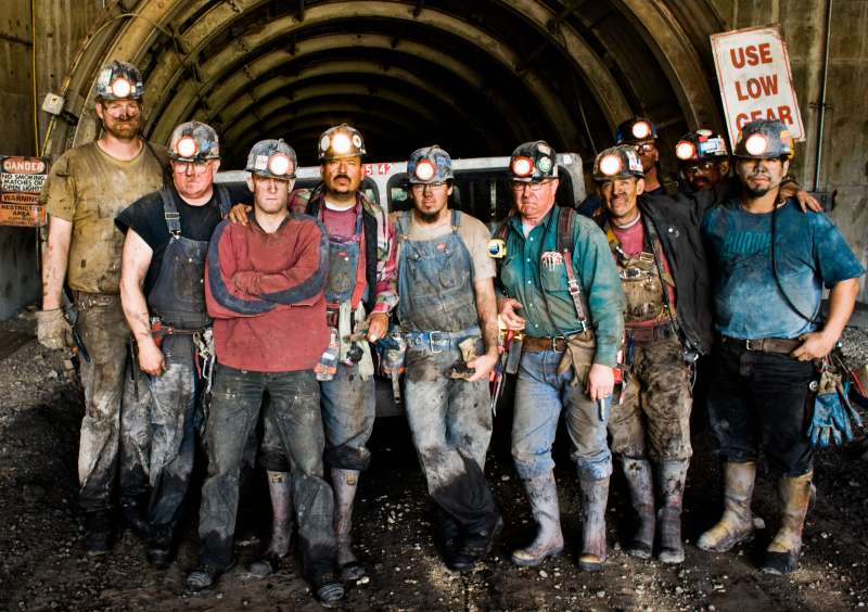 Coal miners in front of mine shaft, portrait