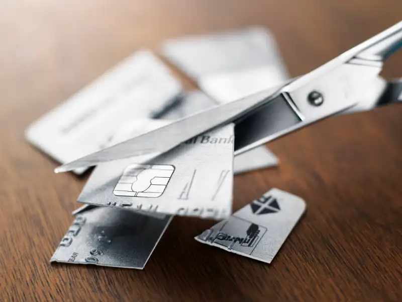 Credit card being cut up with a scissors
