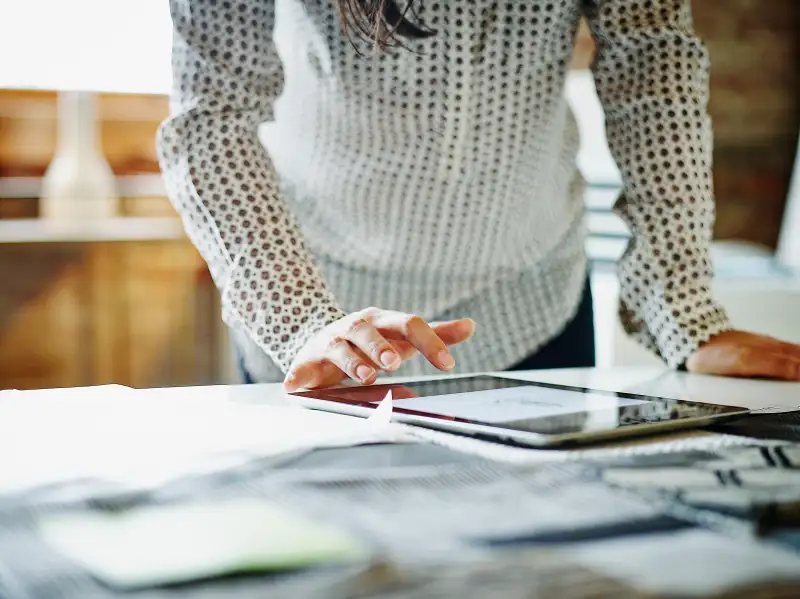 Businesswoman looking at digital tablet in office