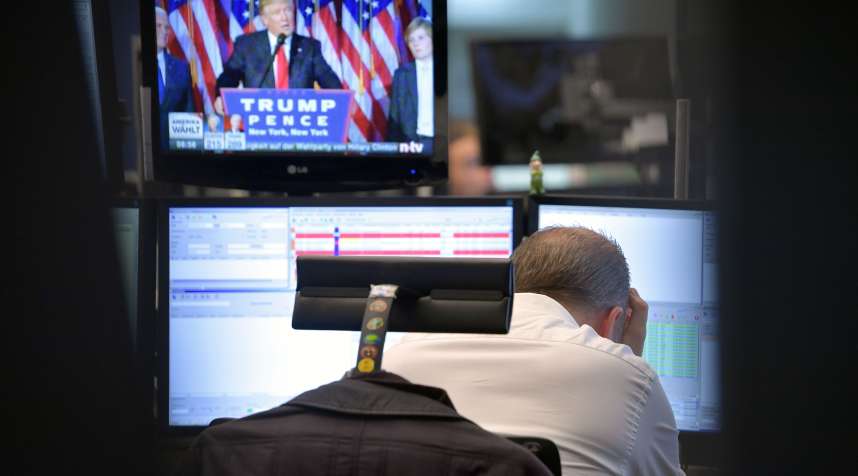 A trader reacts as he watch the speech of Donald Trump at the Frankfurt Stock Exchange on November 9, 2016 in Frankfurt, Germany. Stock markets around the world reacted with volatility to the surprise win for Republican candidate Donald Trump in yesterday's U.S. presidential elections.
