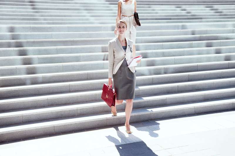 Businesswoman walking down steps outdoors