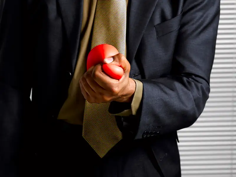 Squeezing stress ball.