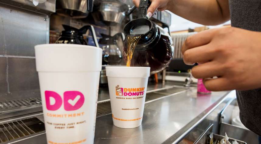 An employee fills a coffee order at a Dunkin' Donuts Inc. location in Ramsey, New Jersey, U.S., on Thursday, May 5, 2016. Dunkin' Brands Group Inc., a leading franchiser in the quick service restaurants (QSR) sector, operates in almost 60 countries around the world with more than 11,300 Dunkin' Donuts restaurants and 7,500 Baskin-Robbins locations. Photographer: Ron Antonelli/Bloomberg via Getty Images