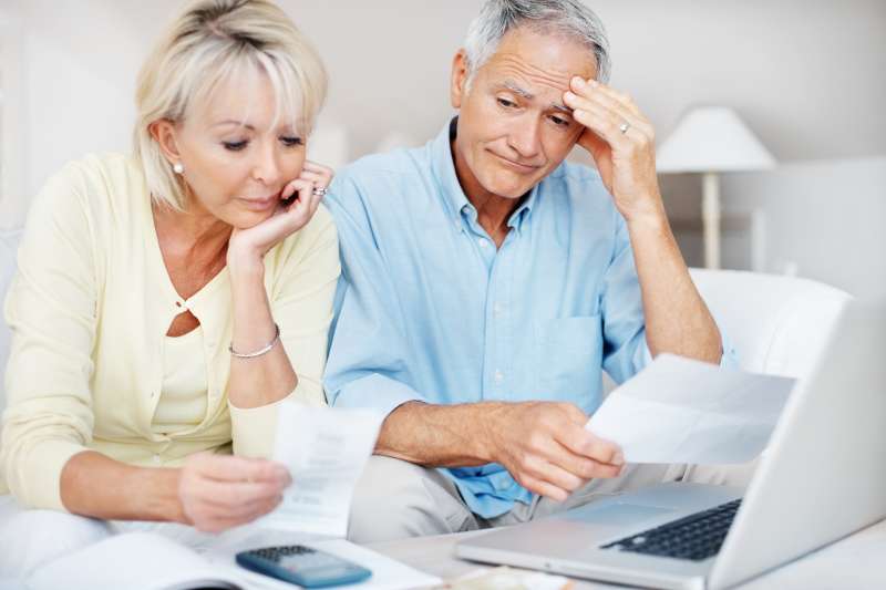 Distressed mature couple angry with so many bills to pay