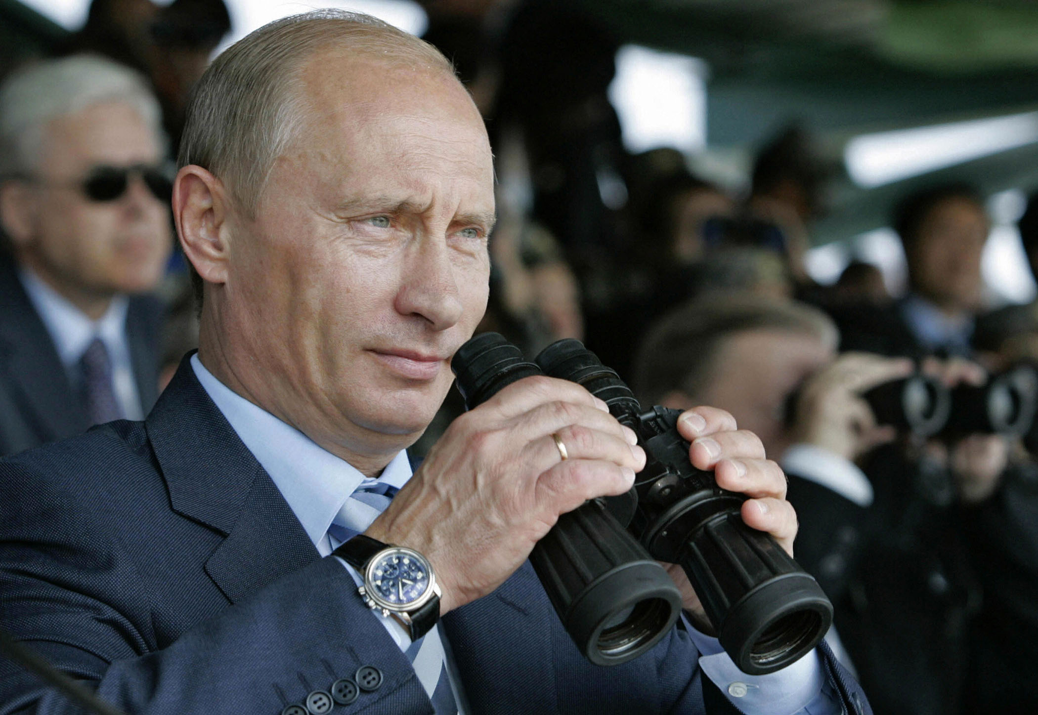 Putin looking through binoculars