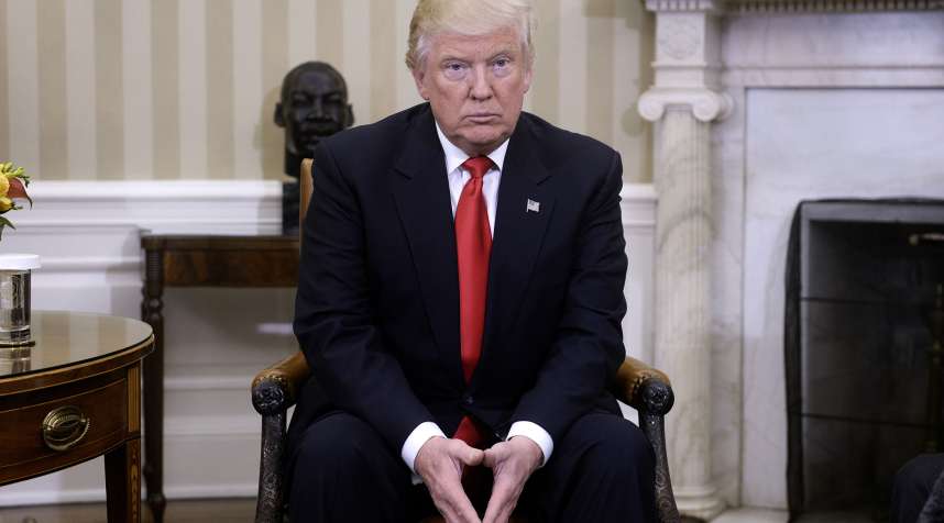 President-elect Donald Trump looks on in the Oval Office of the White House during a meeting with U.S. President Barack Obama on November 10, 2016.
