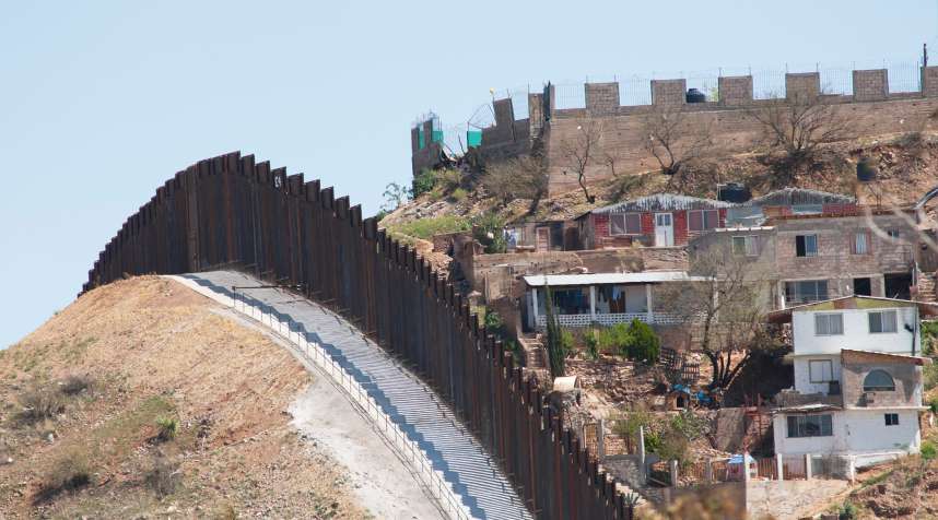 The steel beam border fence overlooks Nogales, Mexico.