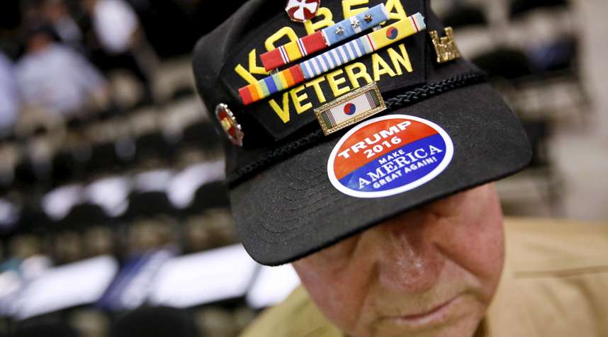 A veteran of both the Korean and the Vietnam War wears a Trump sticker before a 2016 rally in Baton Rouge.