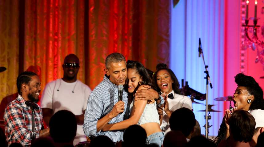 President Barack Obama hugs his daughter Malia Obama on her birthday, celebrated on July 4, 2016. The holiday party featured artists including Janelle Monae and Kendrick Lamar.