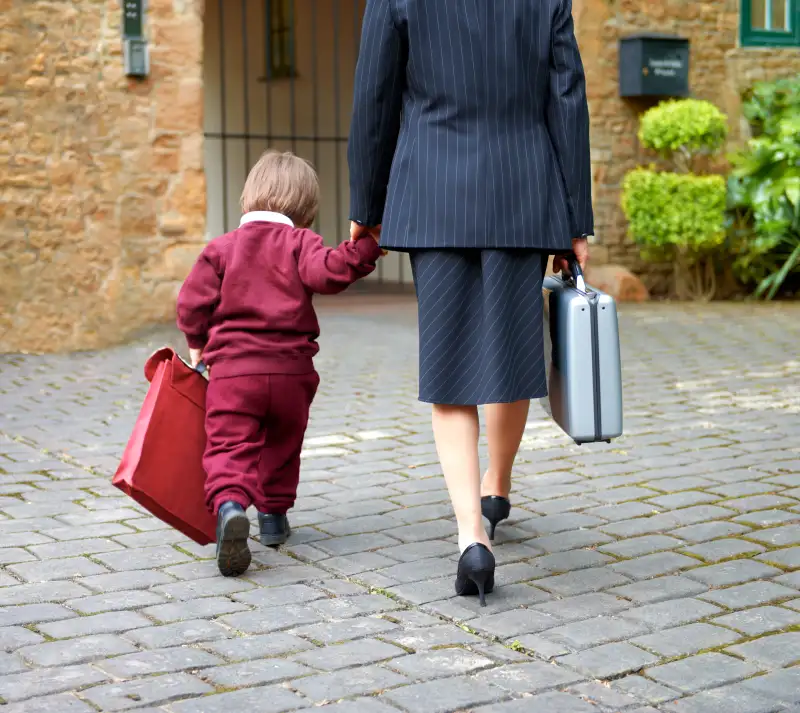 Single working mother taking child to school