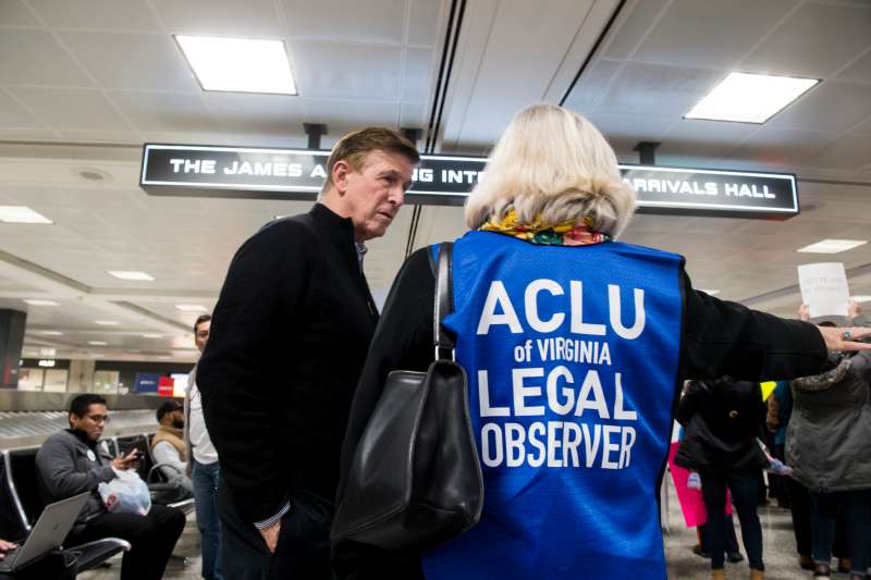 Rep. Don Beyer, D-Va., speaks with an ACLU legal observer during the protest at Dulles International Airport in Virginia on Sunday, Jan. 29, 2017.