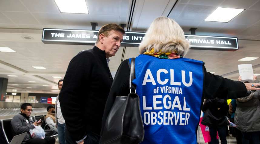 Rep. Don Beyer, D-Va., speaks with an ACLU legal observer during the protest at Dulles International Airport in Virginia on Sunday, Jan. 29, 2017.
